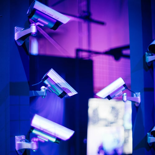 Photo of four surveillance cameras within view in a scifi-looking environment - CHUTTERSNAP on Unsplash
