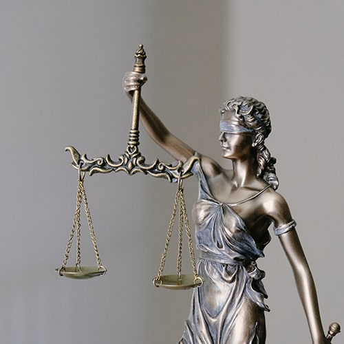 Image of a judicial figurine/statue of Lady Justice, blinded and with scales - Tingey Injury Law Firm on Unsplash