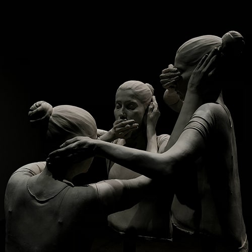 Photo of a statue of three women holding one another's ears, mouth, and eyes for 'See No, Hear No, Speak No Evil' - Teymur Mirzazade on Unsplash
