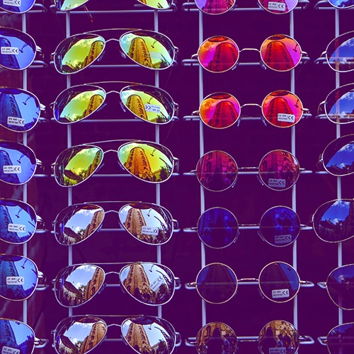 Photo of display racks of aviators with colored lenses