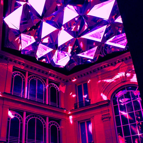 Photo of the interior of a luxury building with an abstract, reflective ceiling