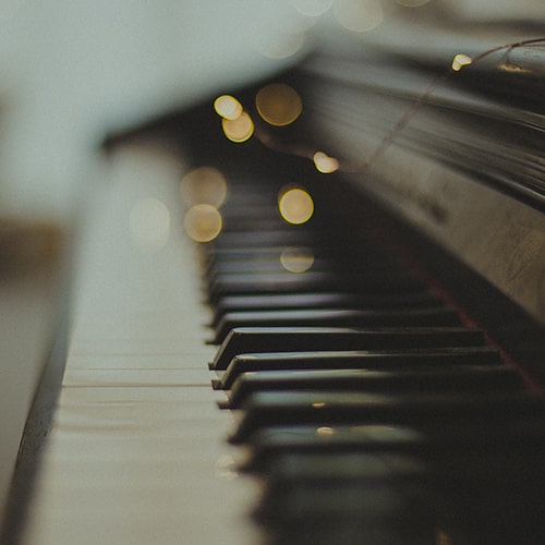 Close-up, semi-focused shot of a piano with a bokeh effect