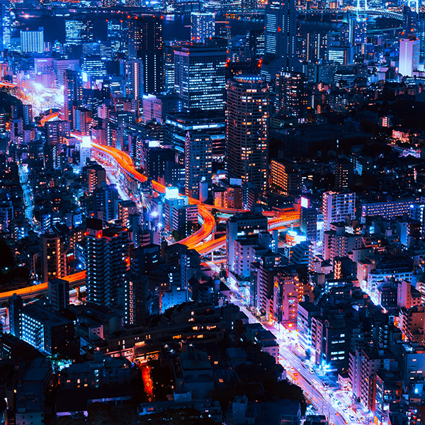 Aerial drone shot of the lit-up cityscape in bright, neon/saturated colors (Tokyo, Japan)